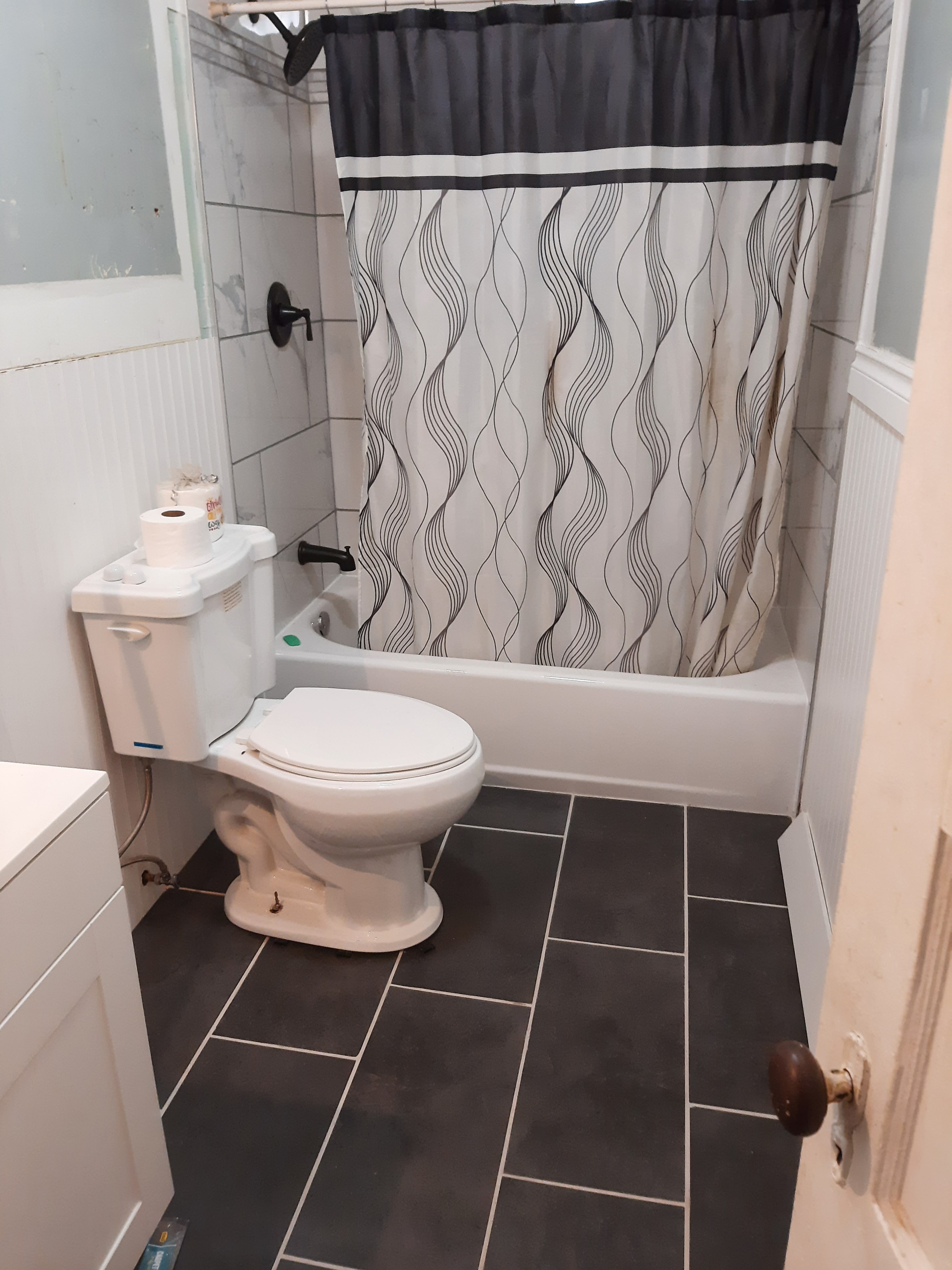 Charcoal large-format tile shower in progress
