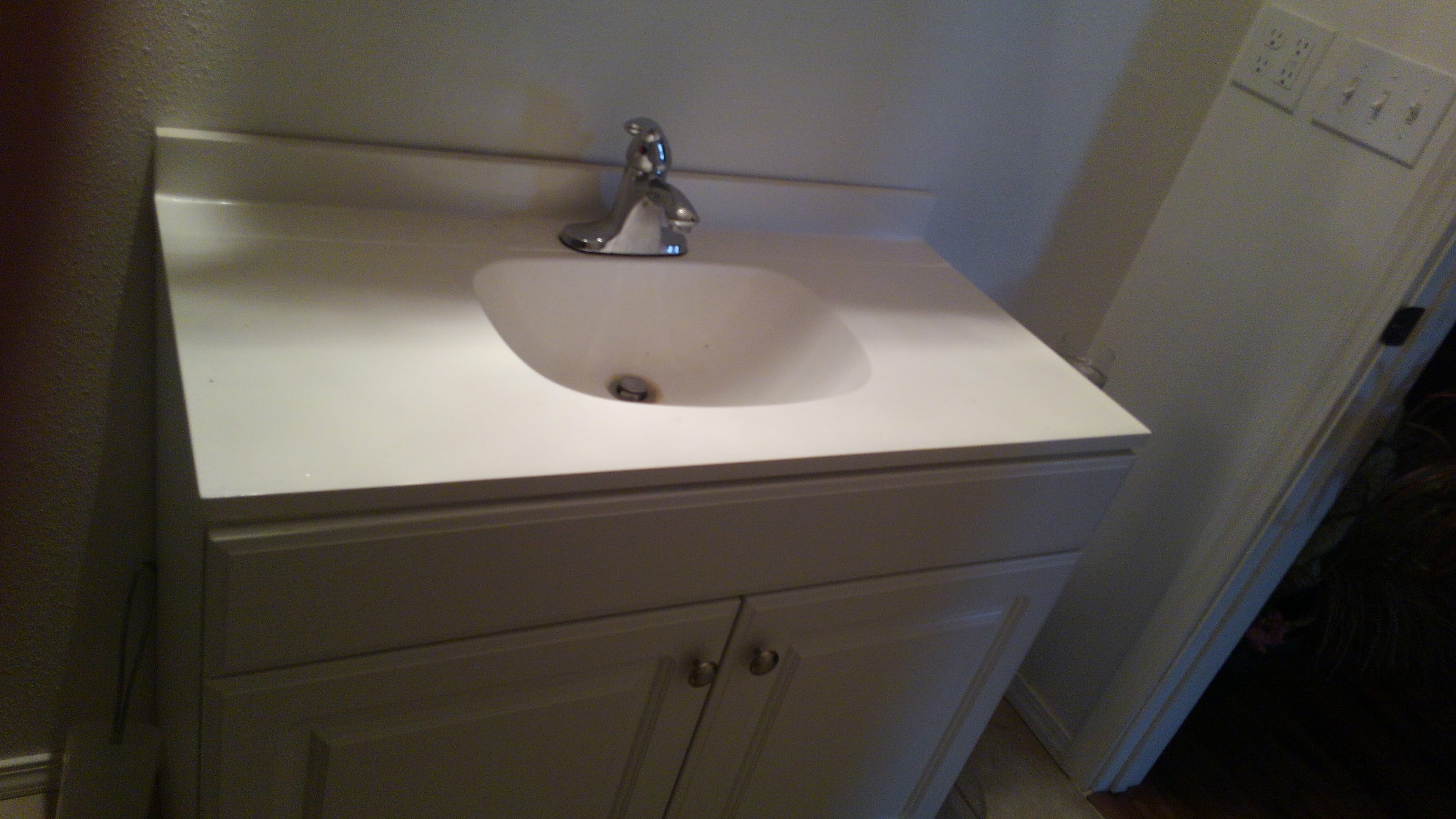 Cultured marble vanity sink with chrome faucet