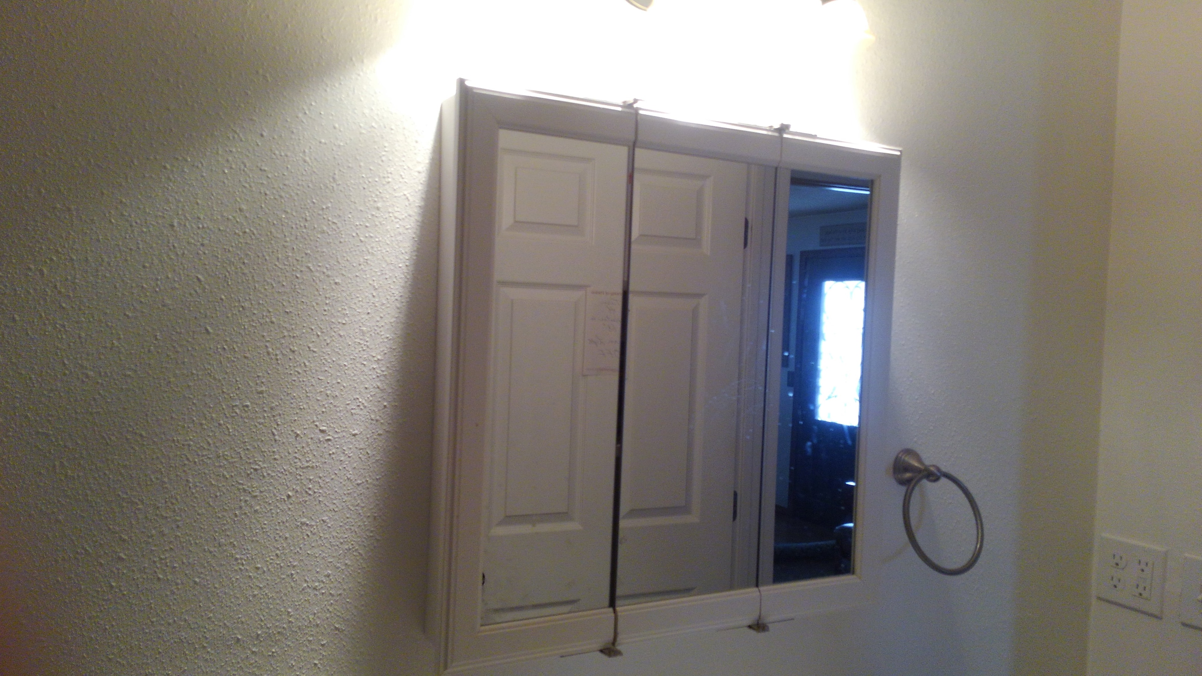 Mirrored medicine cabinet with vanity light bar