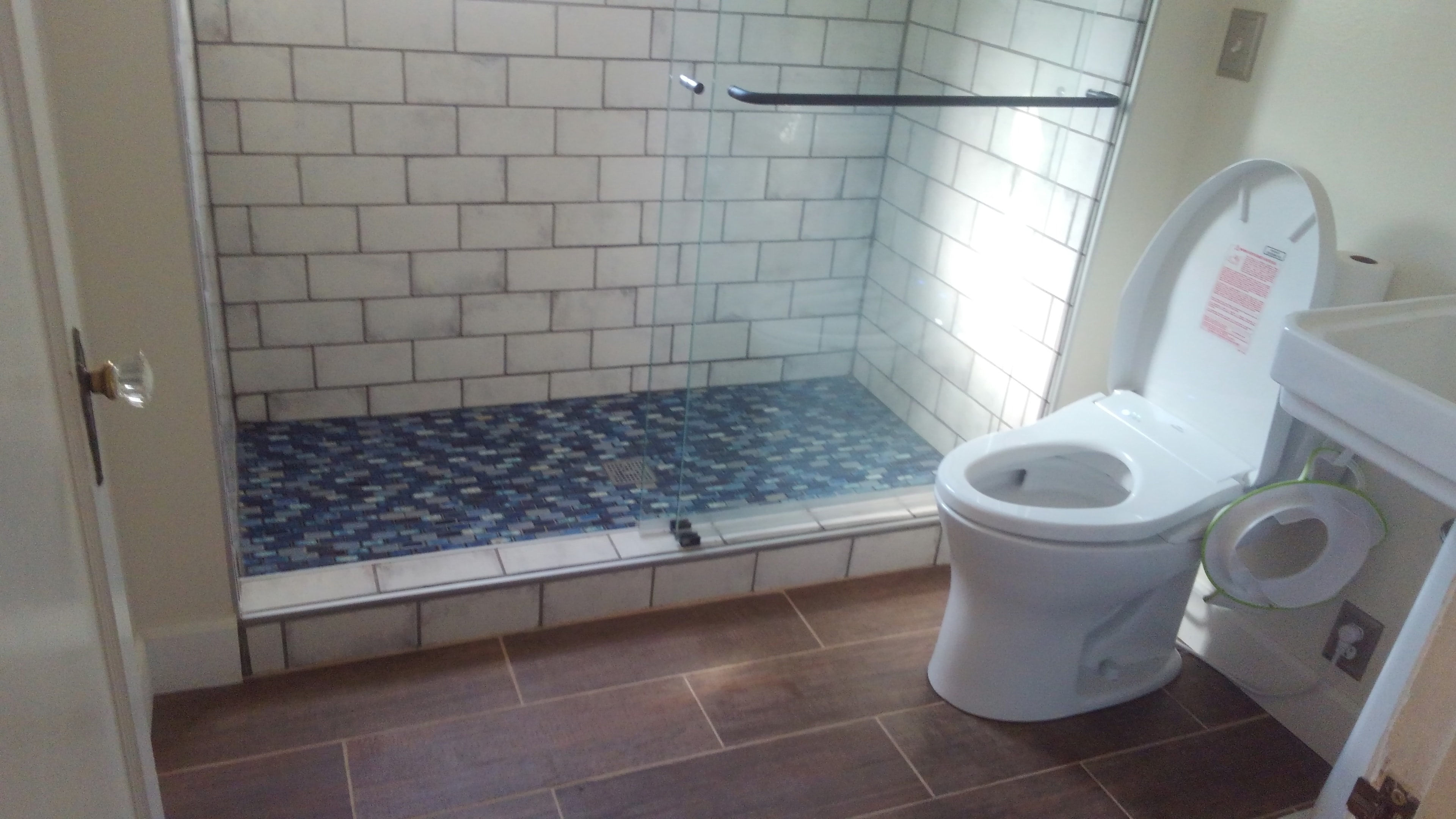 Subway tile shower with glass enclosure