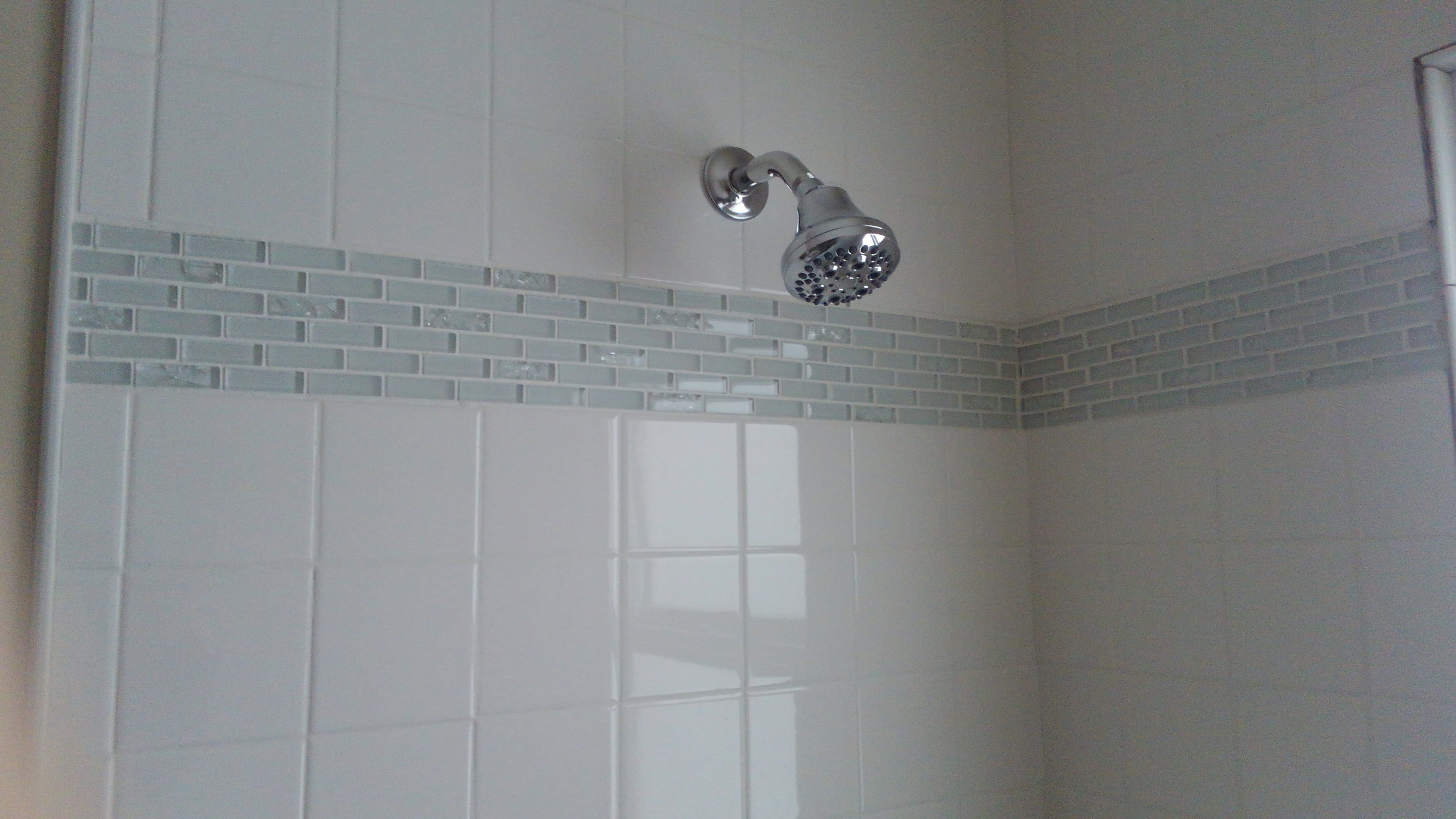 Subway tile shower with glass mosaic floor