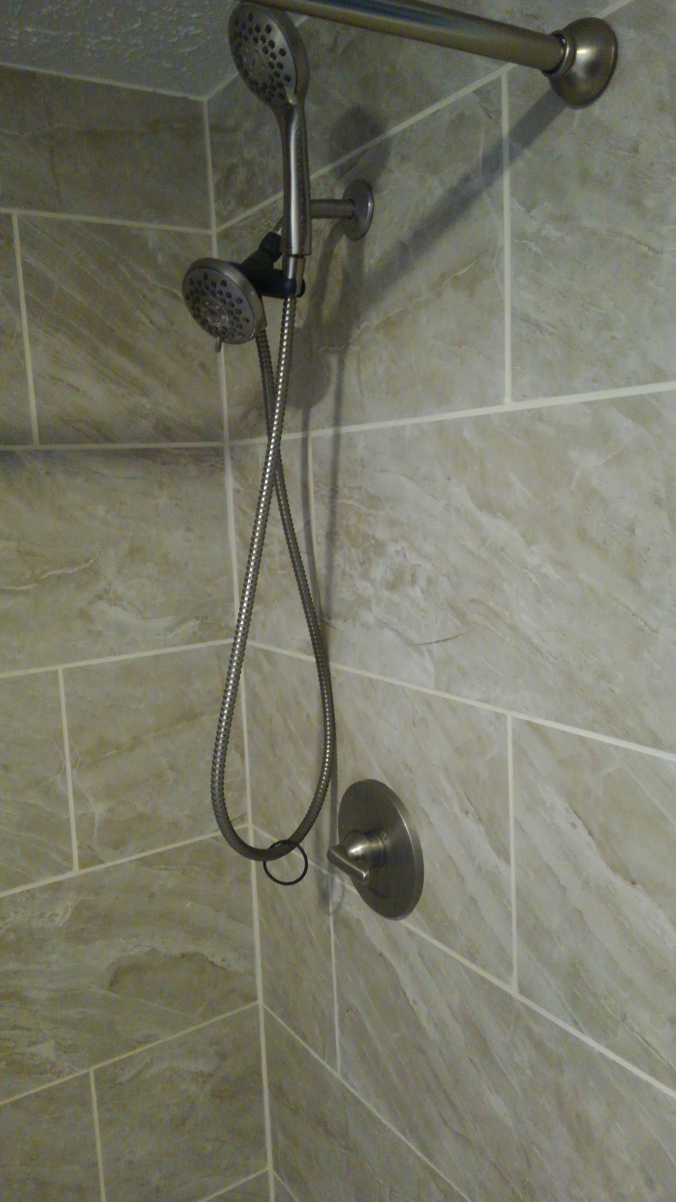 Travertine shower with dual showerheads