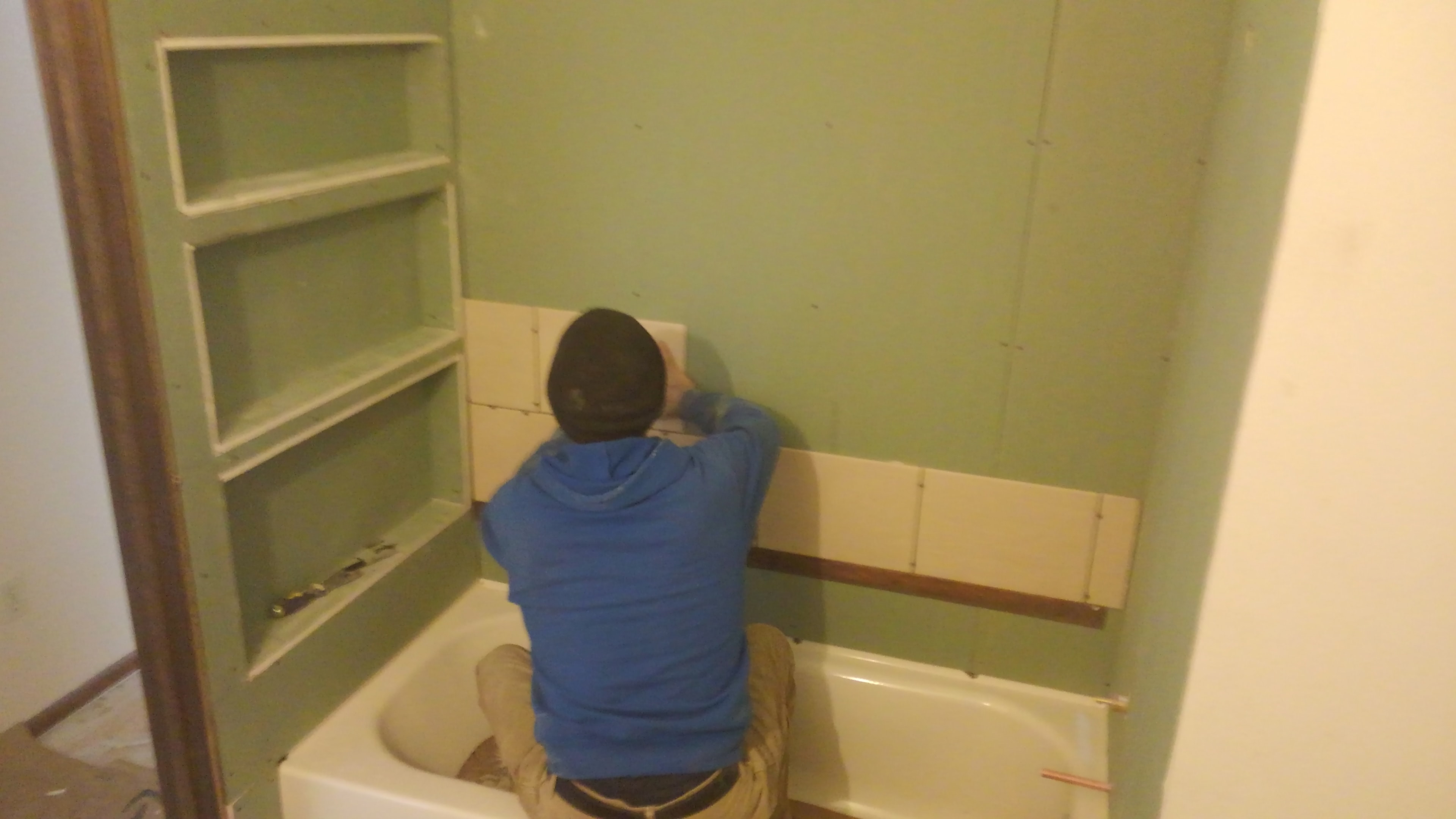 Tub surround tile installation in progress