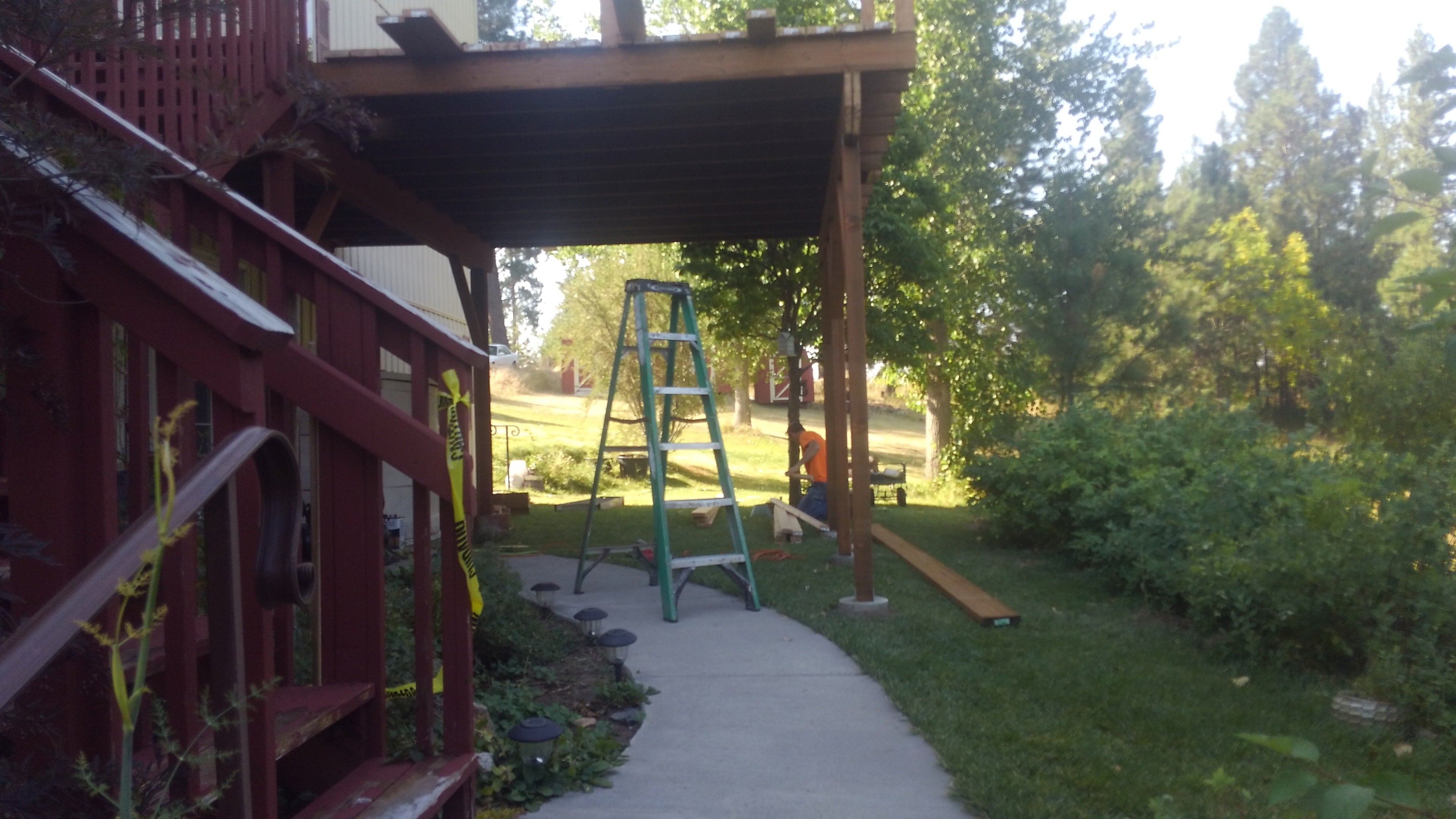Covered patio framing with worker on site