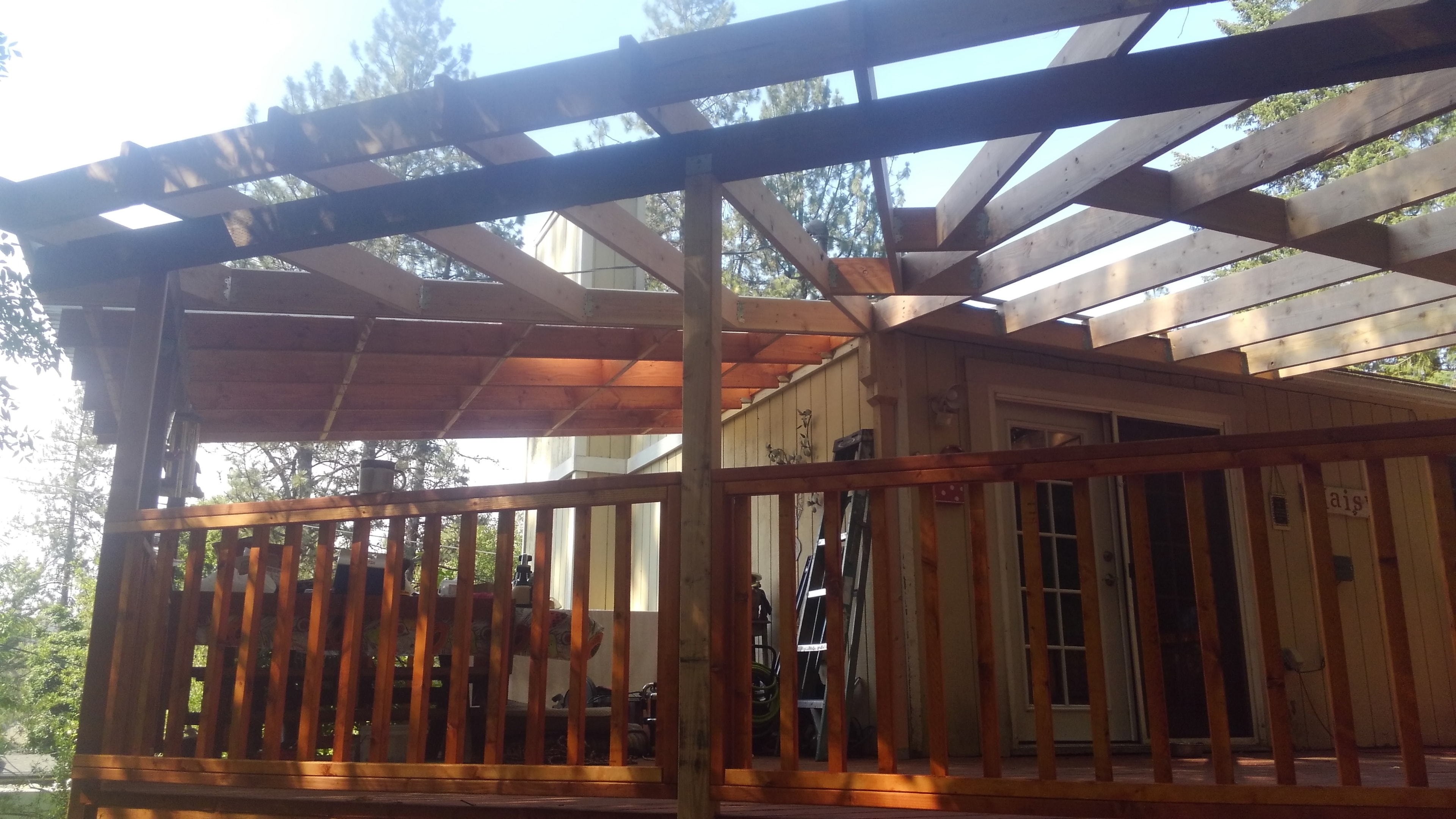 Pergola platform with cedar posts in wooded setting