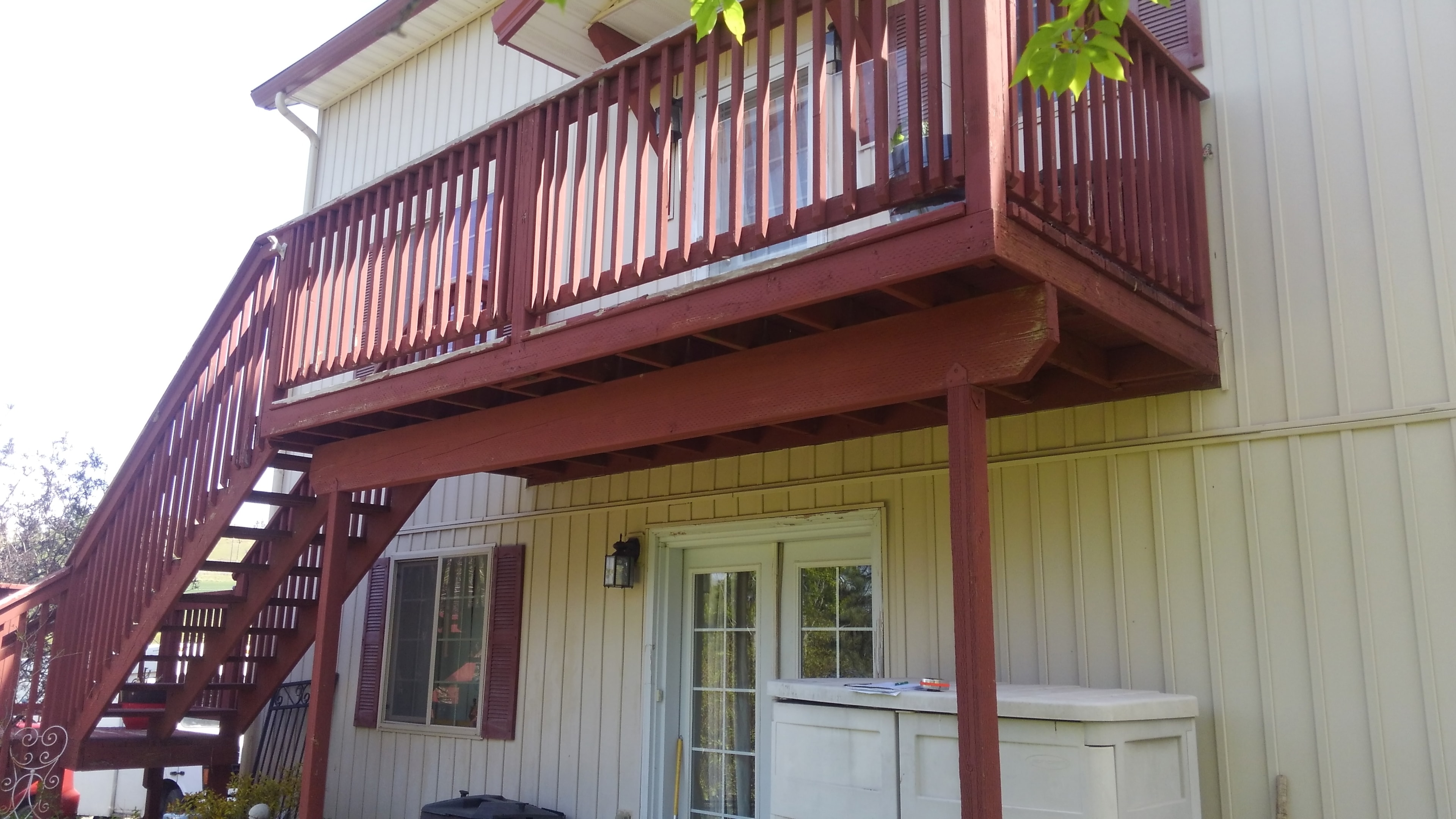 Second-story deck with burgundy-stained railings