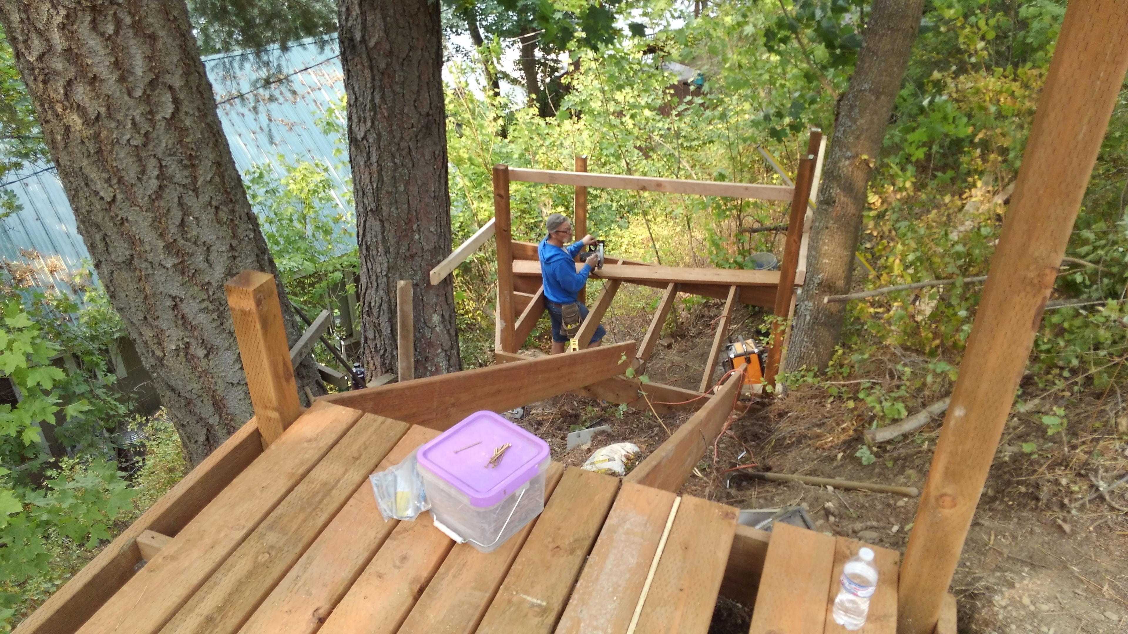 Wooded deck framing with worker on site