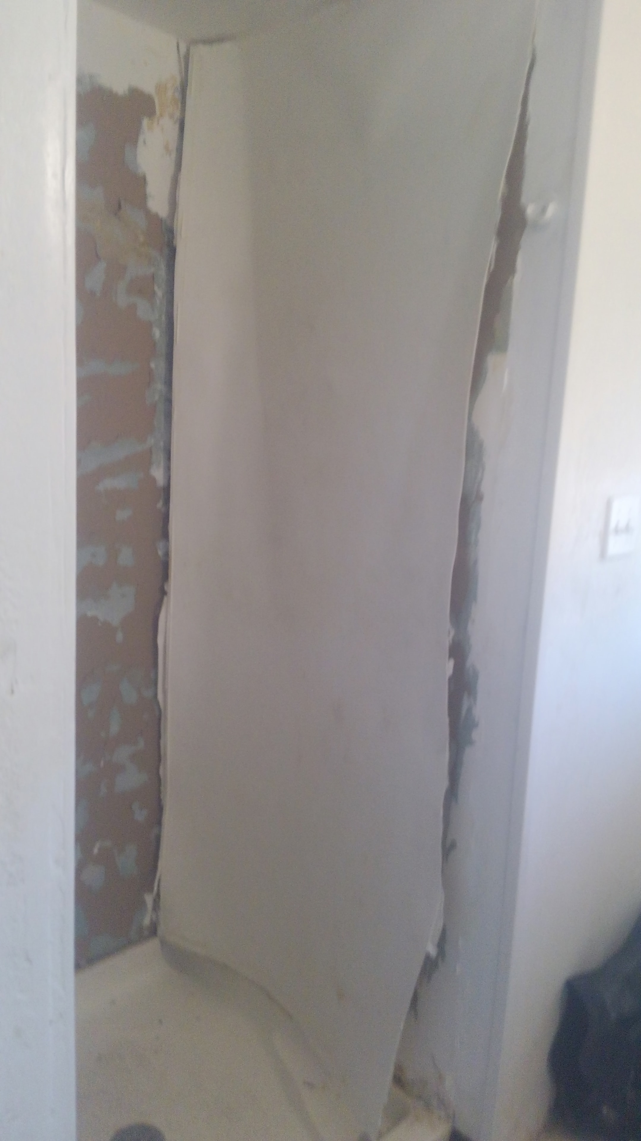 Tile removal and drywall repair in progress
